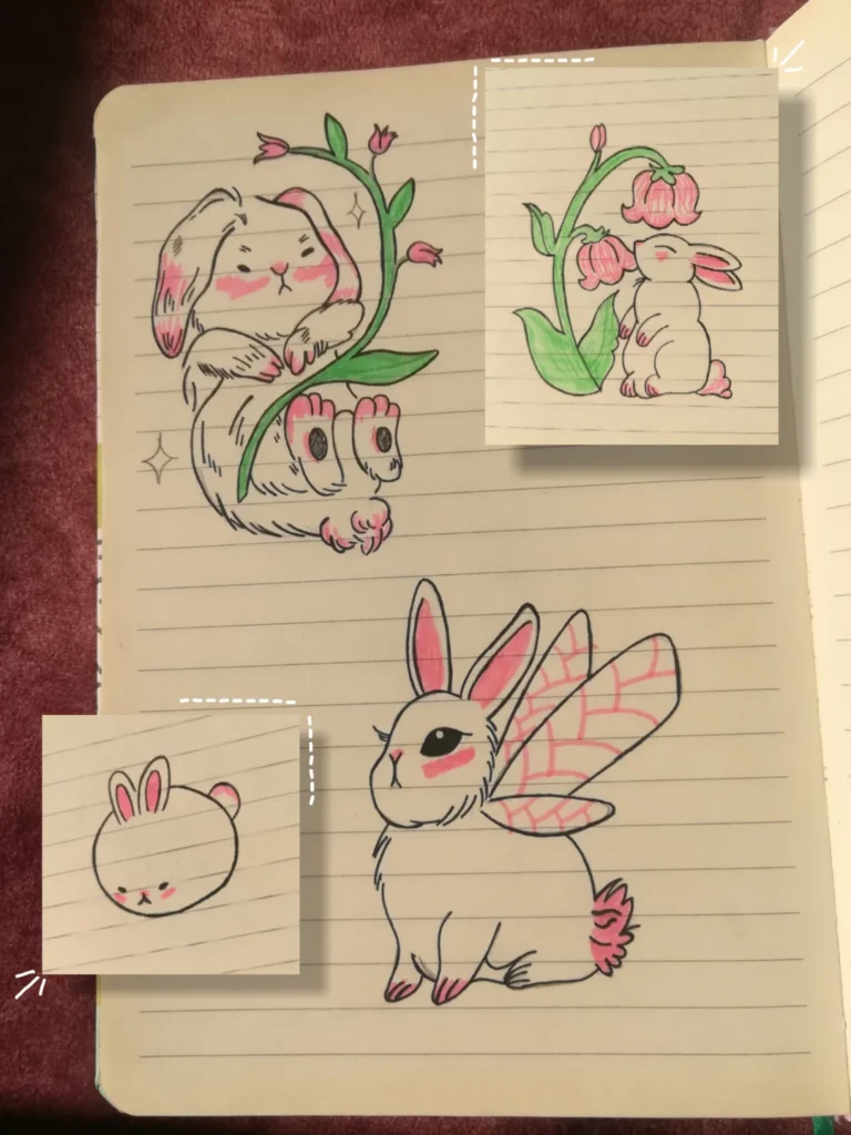 Collection of hand-drawn bunnies in a notebook, including a bunny holding flowers, a bunny with fairy wings, and small bunny head sketches.